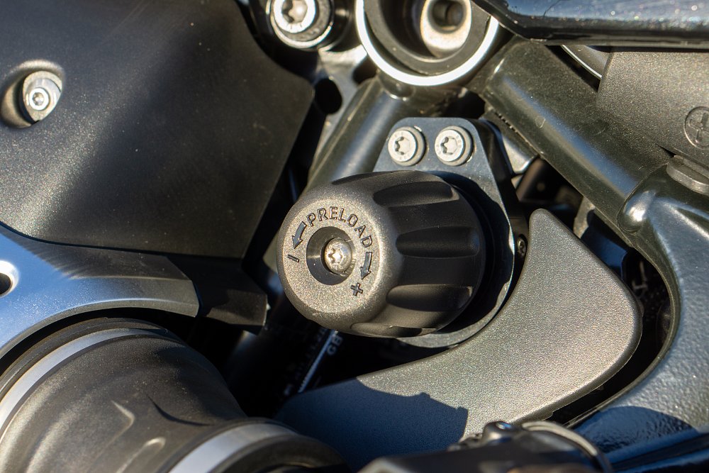 The rear shock's preload adjuster knob mounted just under the R 12's fuel tank. 