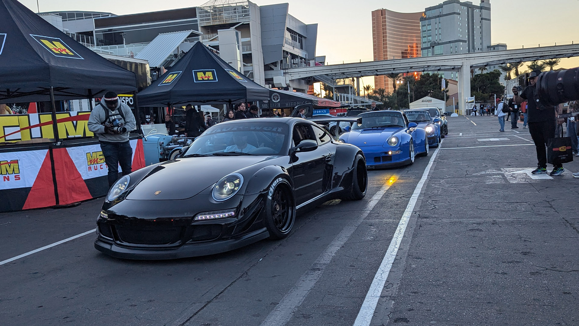 Row of custom Porsches leaving SEMA 