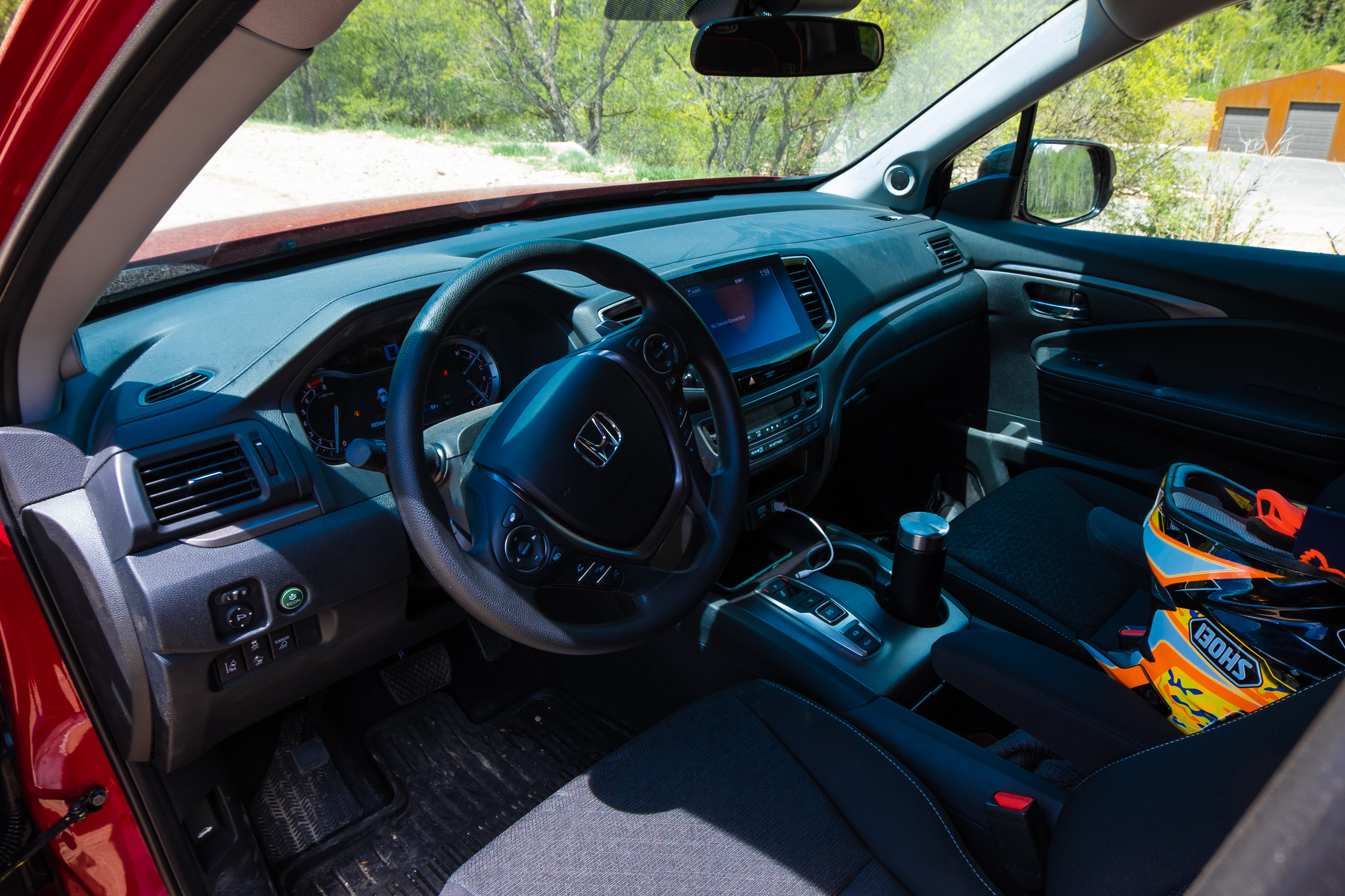 The Ridgeline's cockpit and the author's Shoei dirtbike helmet